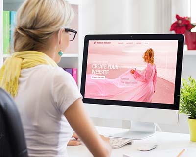 a woman infront of a computer screen with a online store on it